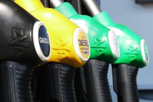 fuel pistols in a petrol station Three types of fuel pistols in three colors. Each one represent a type of fuel (black is gasoline, yellow is diesel an green is natural gas