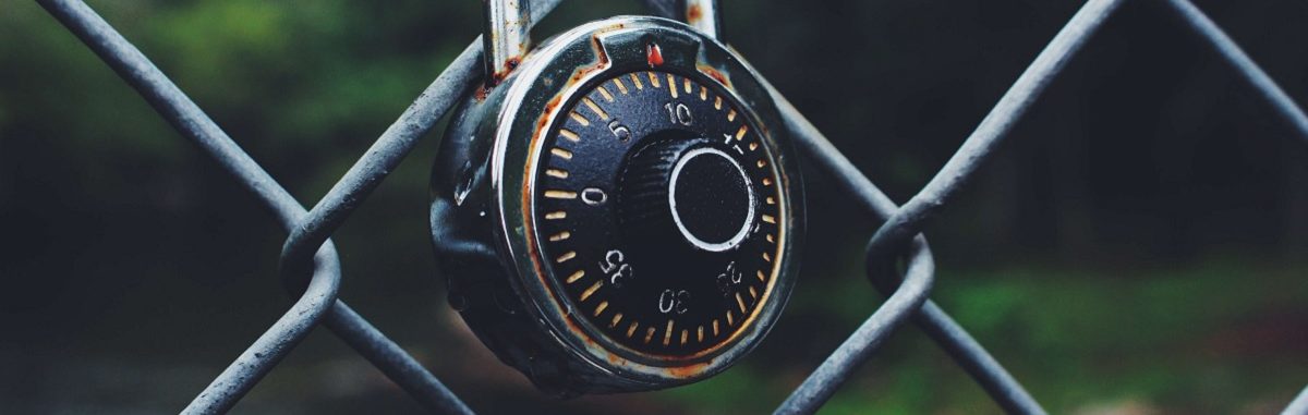 Image of a padlock hooked to a gate