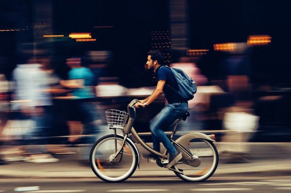 A man riding a bicycle getting to work.