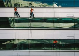 Trabajadores limpiando cristales en altura