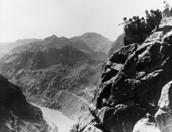 Pointing out a potential location for the dam in the canyon of Colorado River