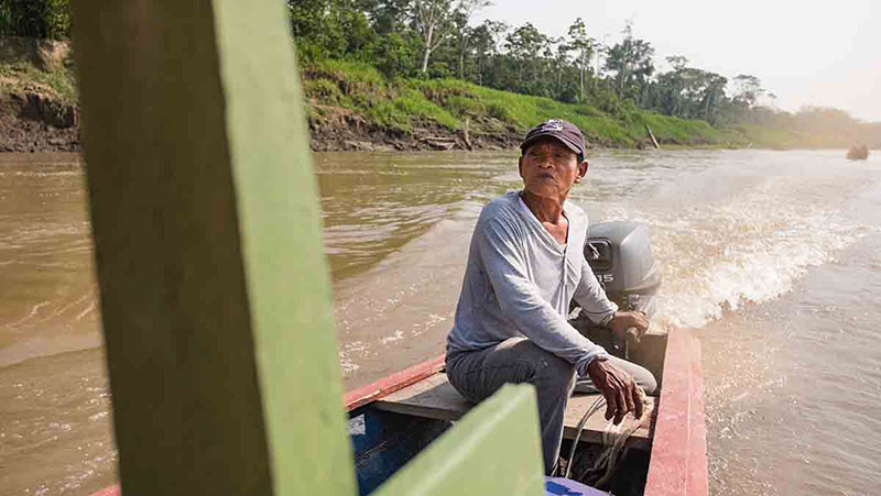 A boat sails down the river towards Puerto Nariño, Colombia
