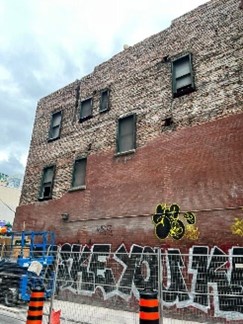 Salvaging the classic red bricks to be used to restore the main facade in the future